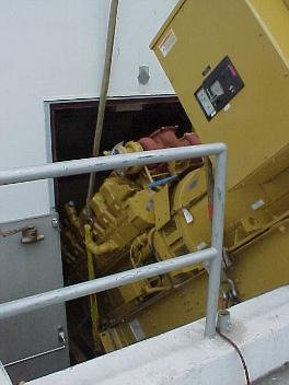 Caterpillar, 3512, close up view of the engine generator skid passing through a tight basement doorway.
