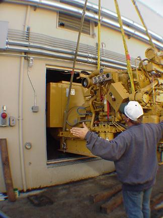 Caterpillar 3412 diesel standby emergency generator being rigged into a San Francisco area telecommunications central office.