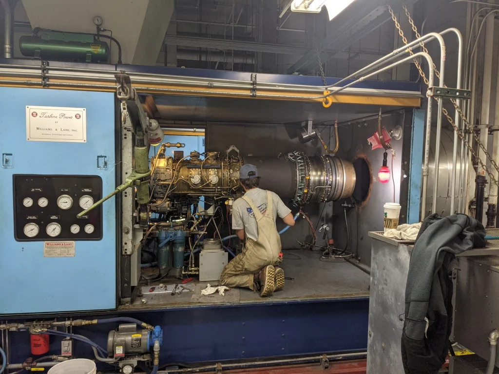 NAPC team member working on a jet engine